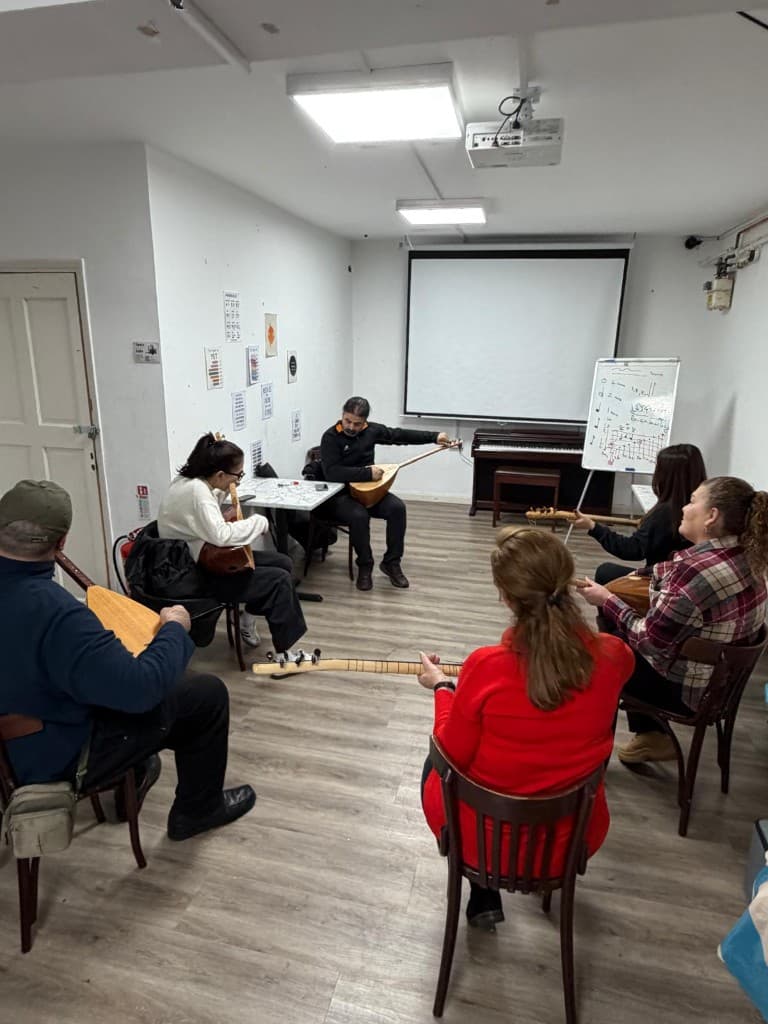 Adults learning bağlama in a community music class at UMW