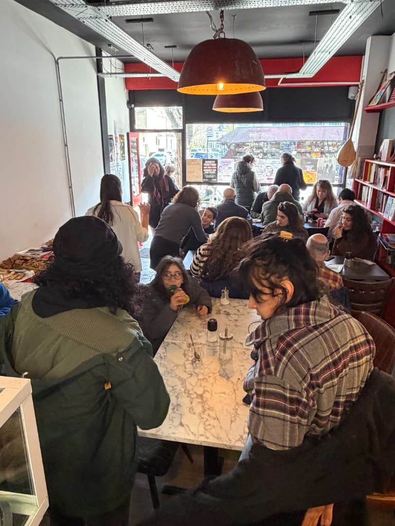 Community members sharing a meal and socialising together at the UMW hub