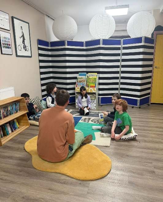 Children in a small-group reading and discussion session at UMW