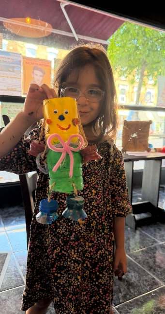 Child with an individually designed recycled sculpture