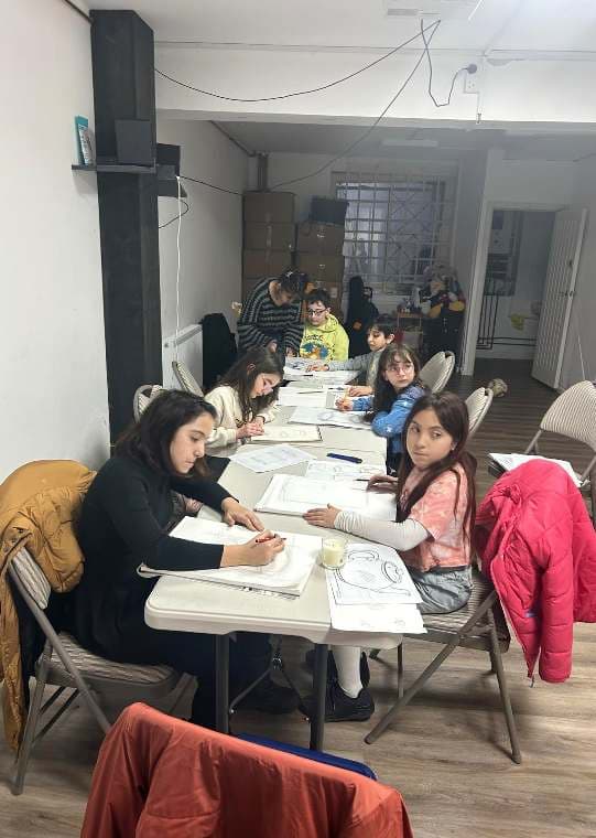 Children drawing and painting in a supervised UMW art session