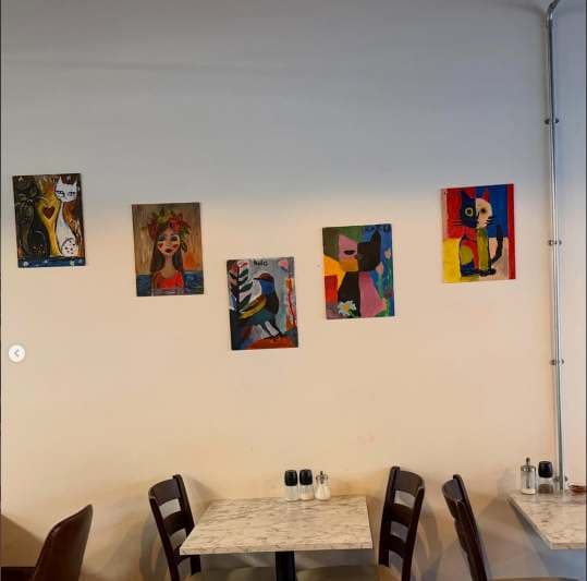 Children's finished artwork displayed in the UMW community venue